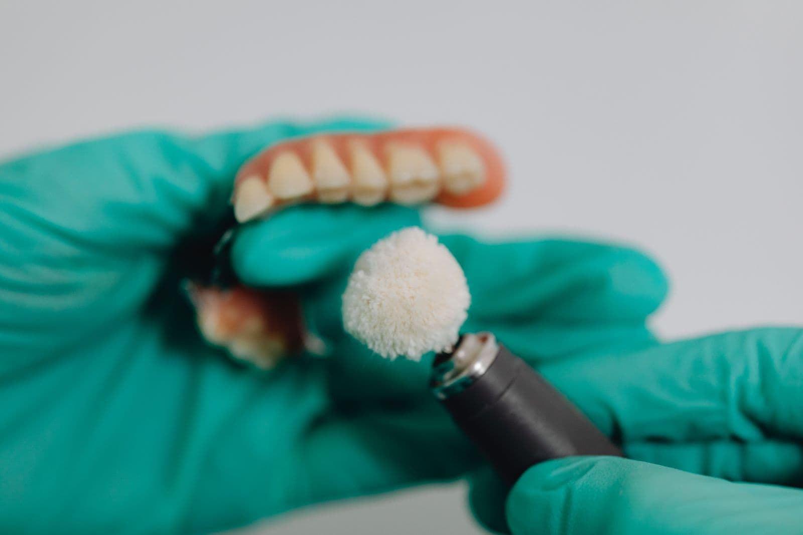 Close-up of a denture being polished