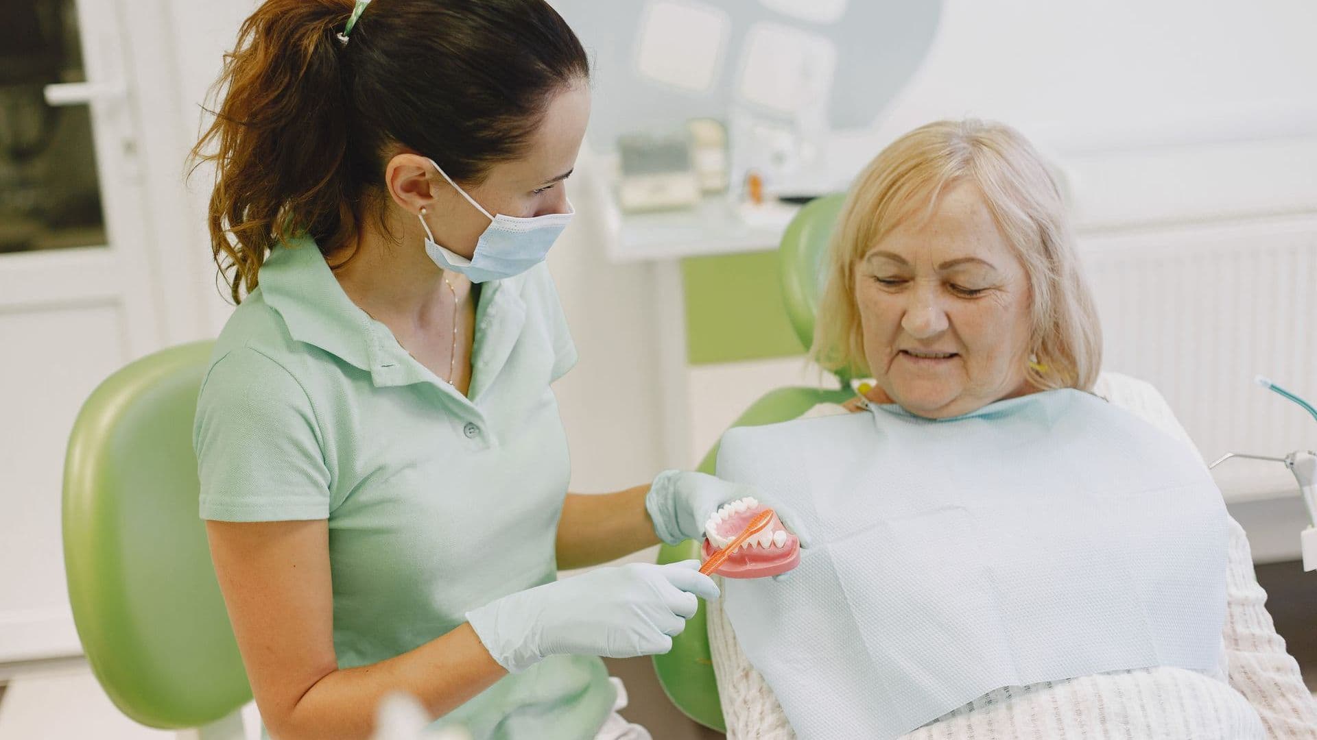 Dentist showing a patient their new dentures