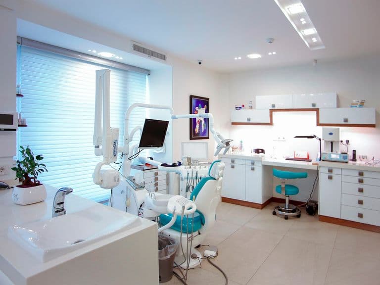 Modern dental office interior with chair and equipment
