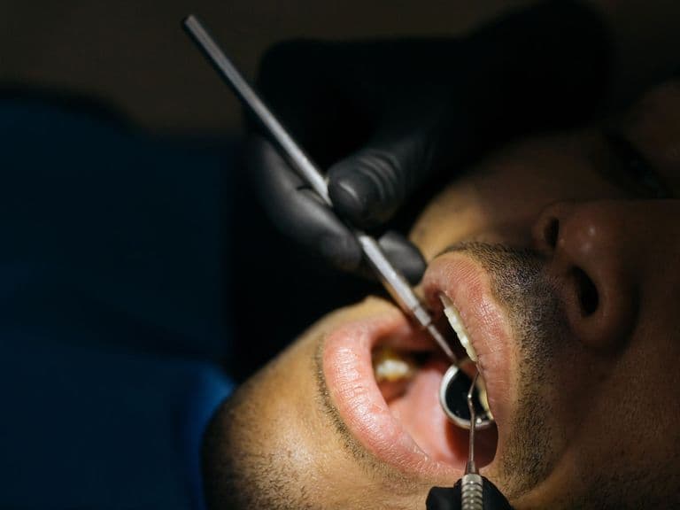 Dentist examining a patient's smile ahead of gum contouring