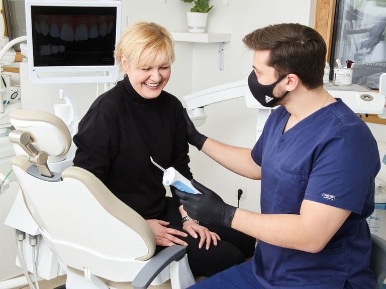 Dentist talking with a patient about lip repositioning