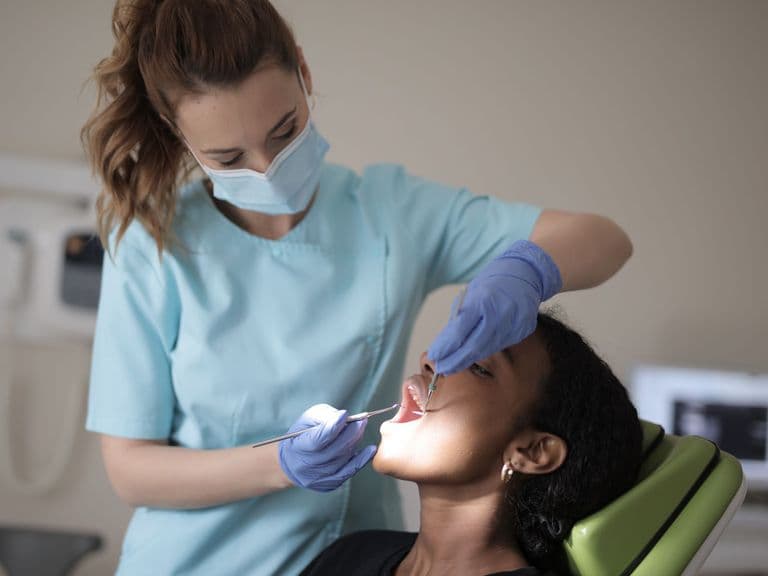 Dentist reassuring a patient before a tooth extraction