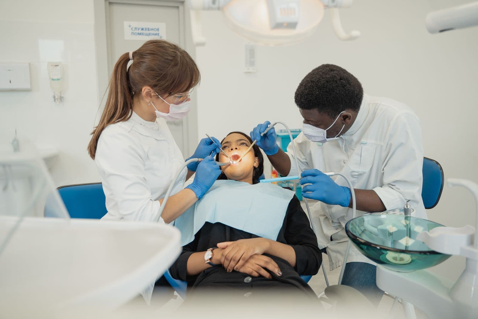 Dentist and assistant treating a patient at Distinctly Dental