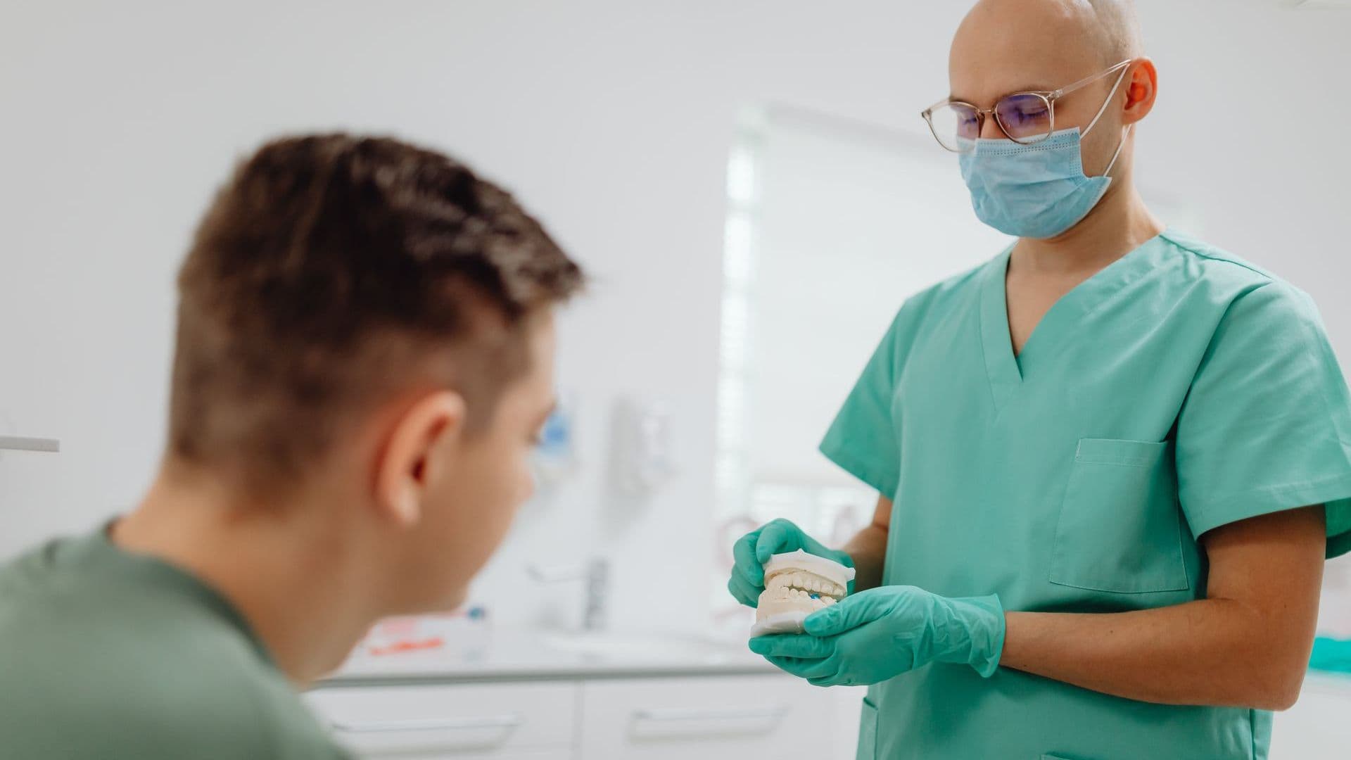 Dentist discussing crowns and bridges treatment with a patient