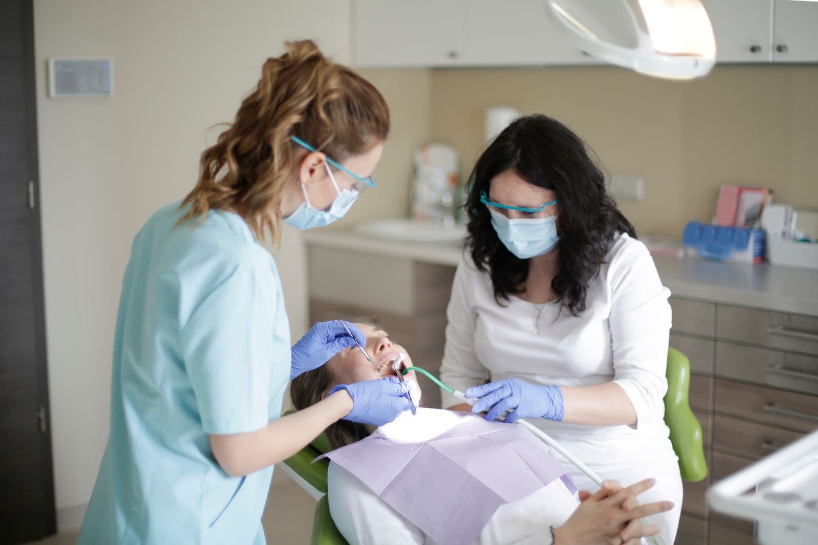Dental hygienist examining a patient's teeth
