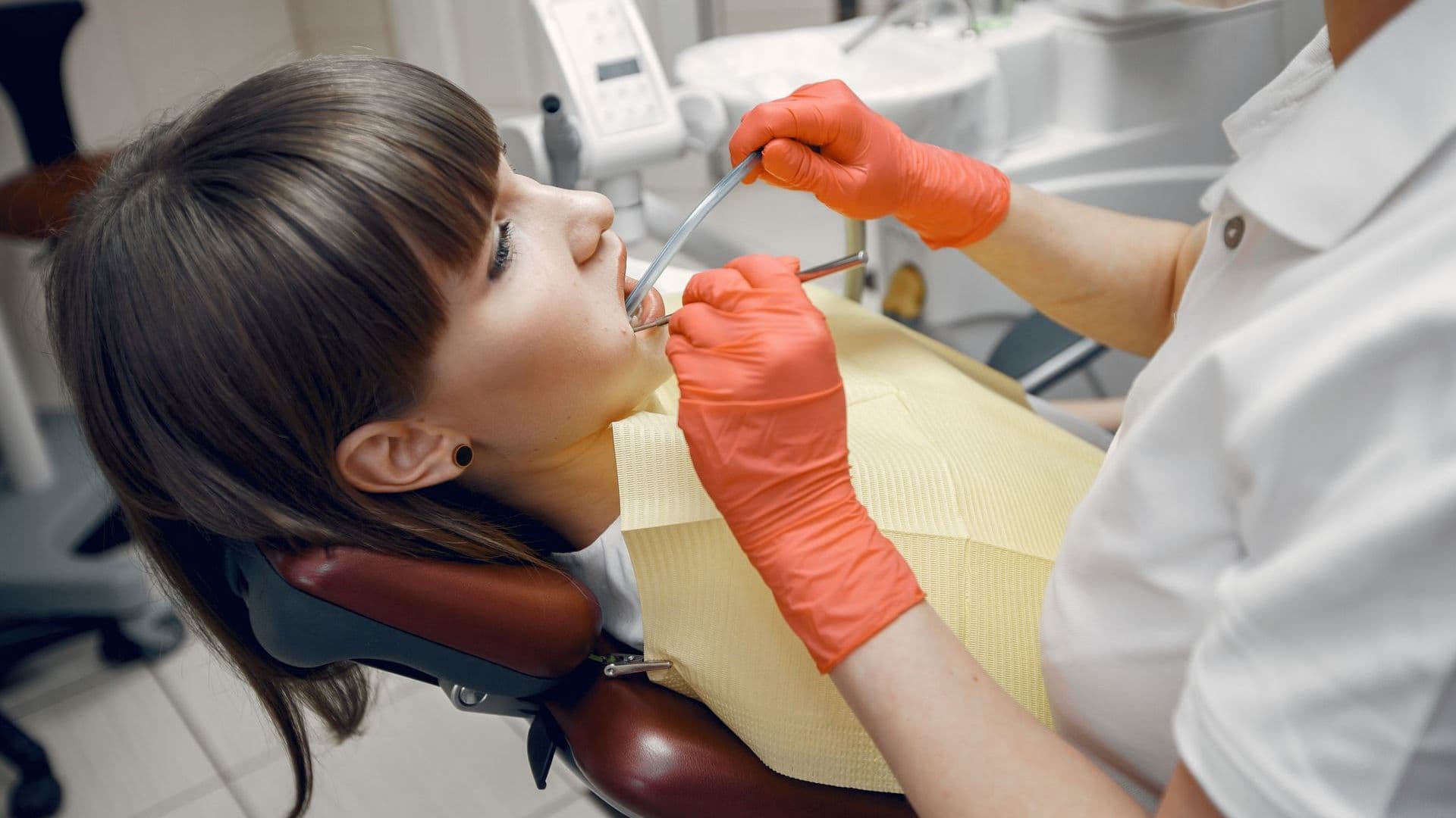 Dental hygienist demonstrating proper tooth brushing technique