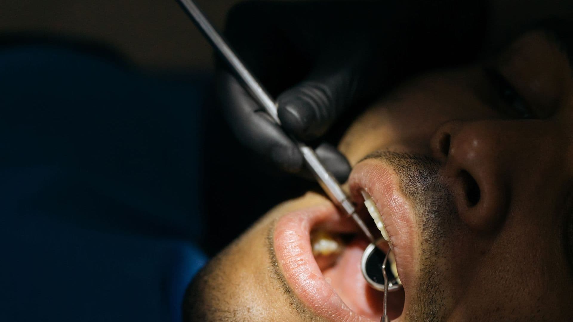 Dentist examining a patient's smile ahead of gum contouring