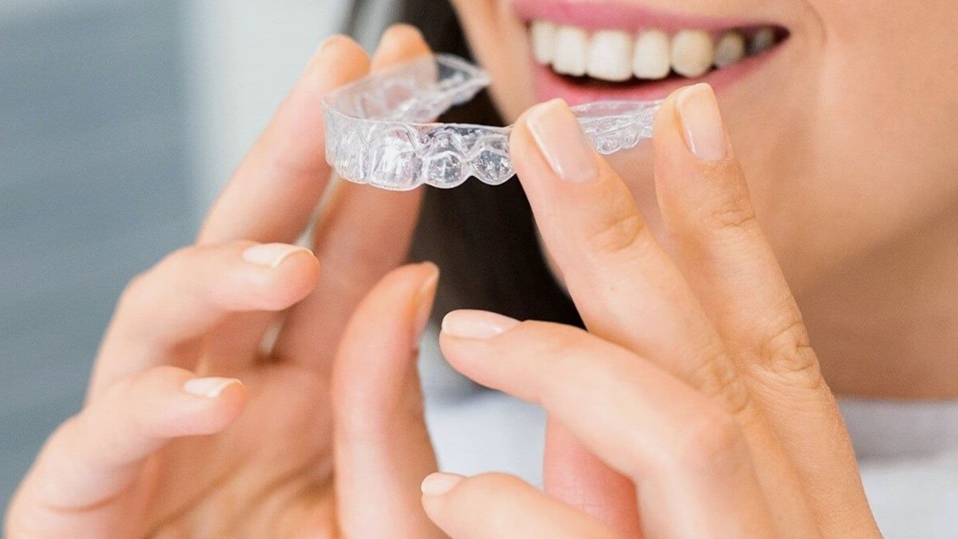 Patient being fitted with a clear Invisalign aligner
