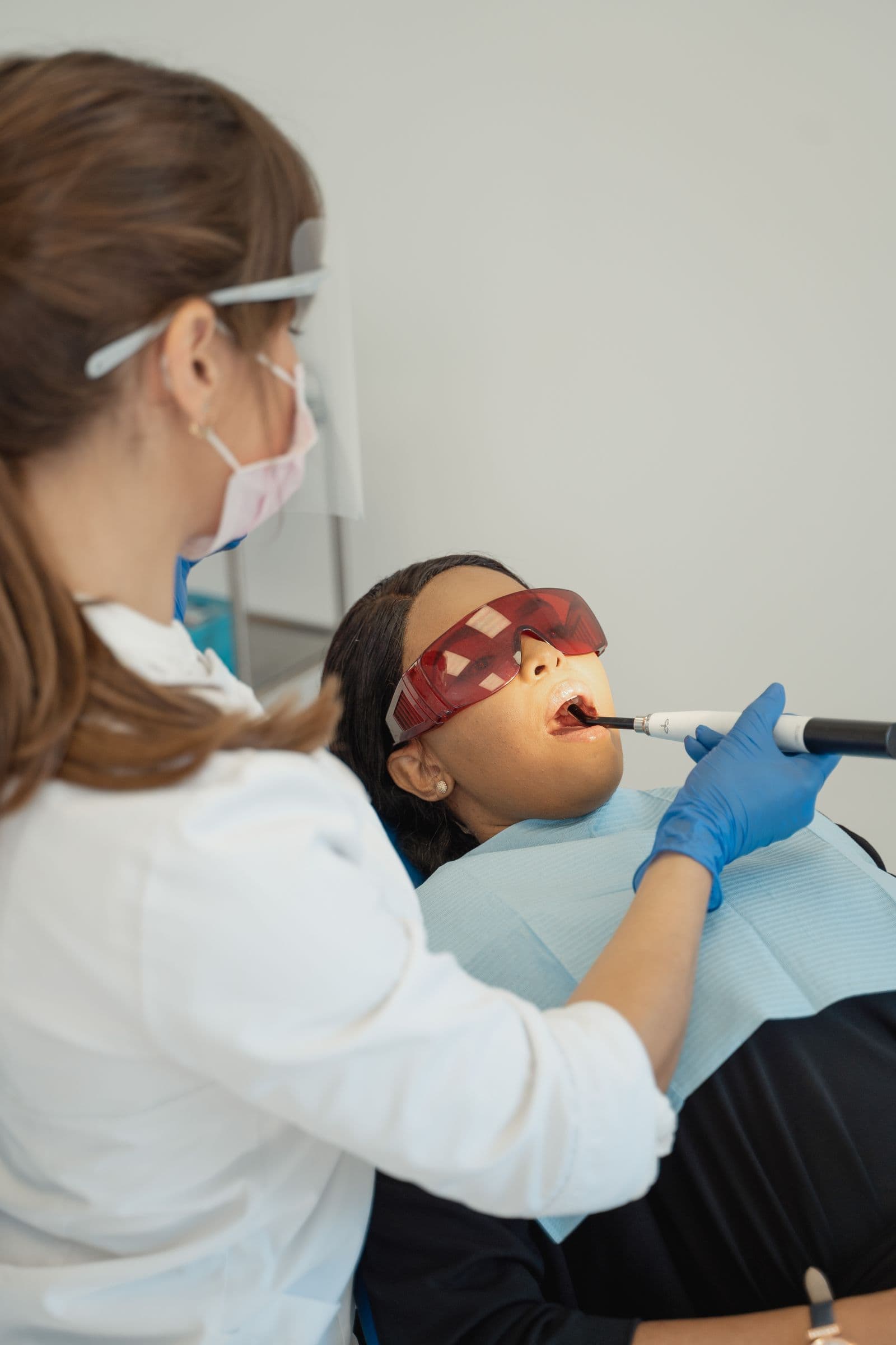 Dentist using advanced light-based dental technology
