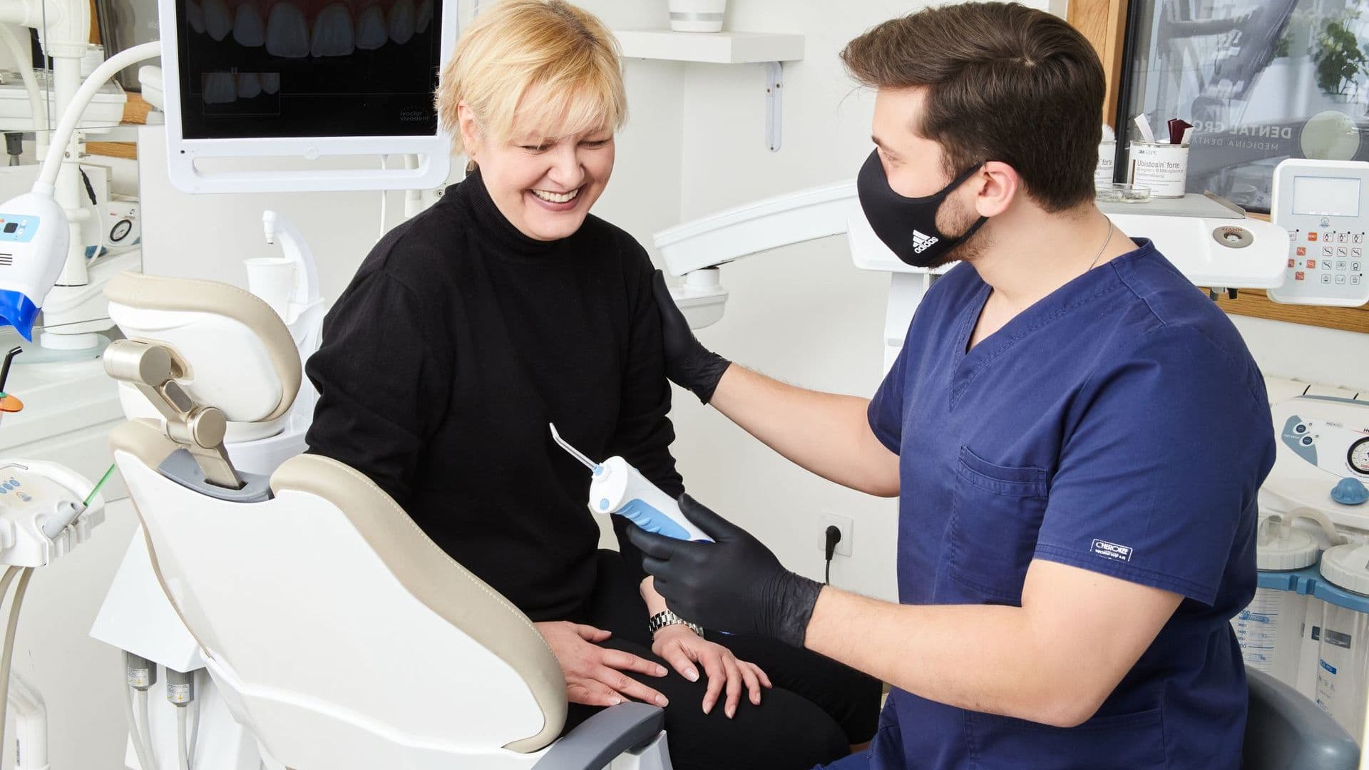 Dentist talking with a patient about lip repositioning