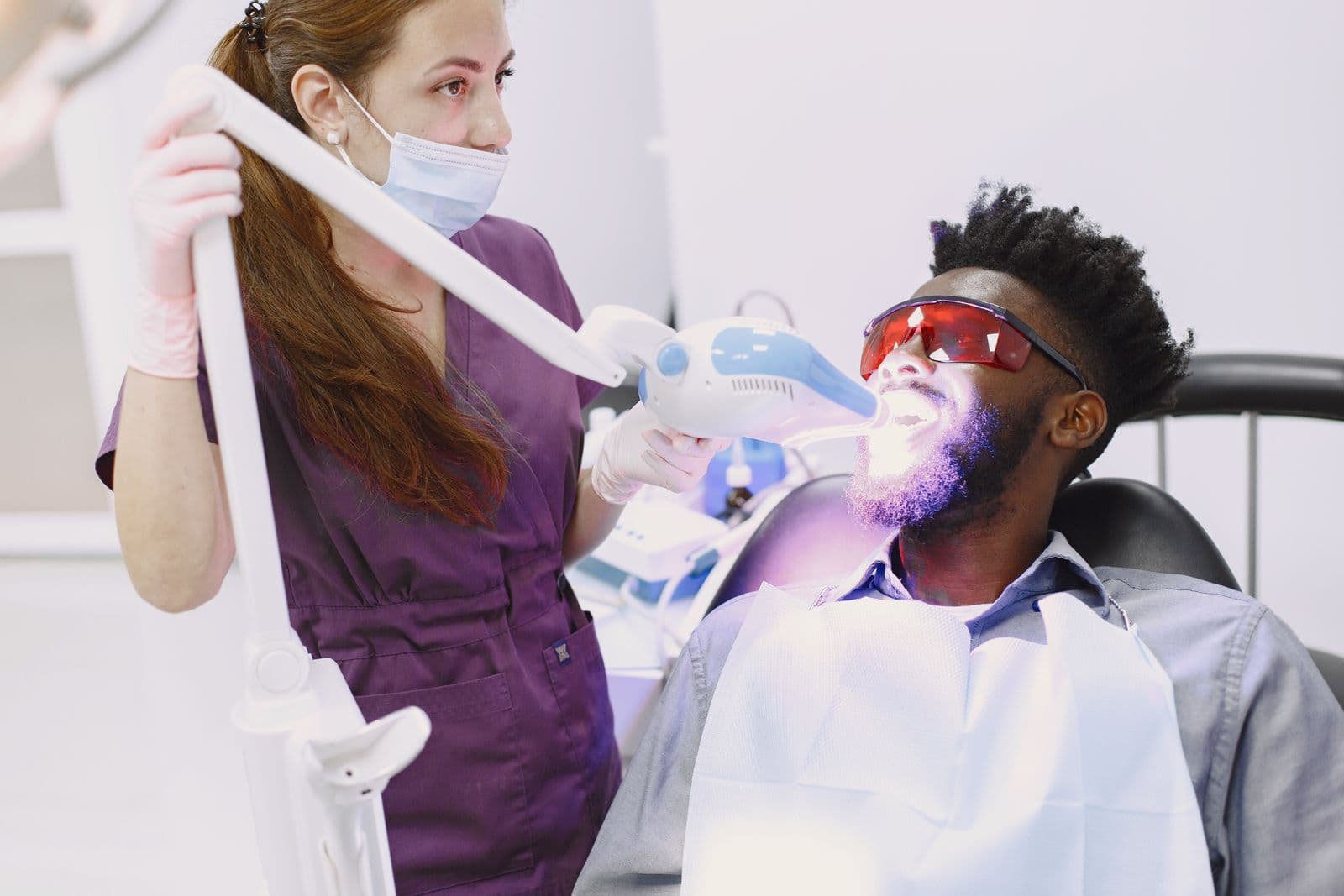 Dentist carrying out a professional teeth whitening treatment